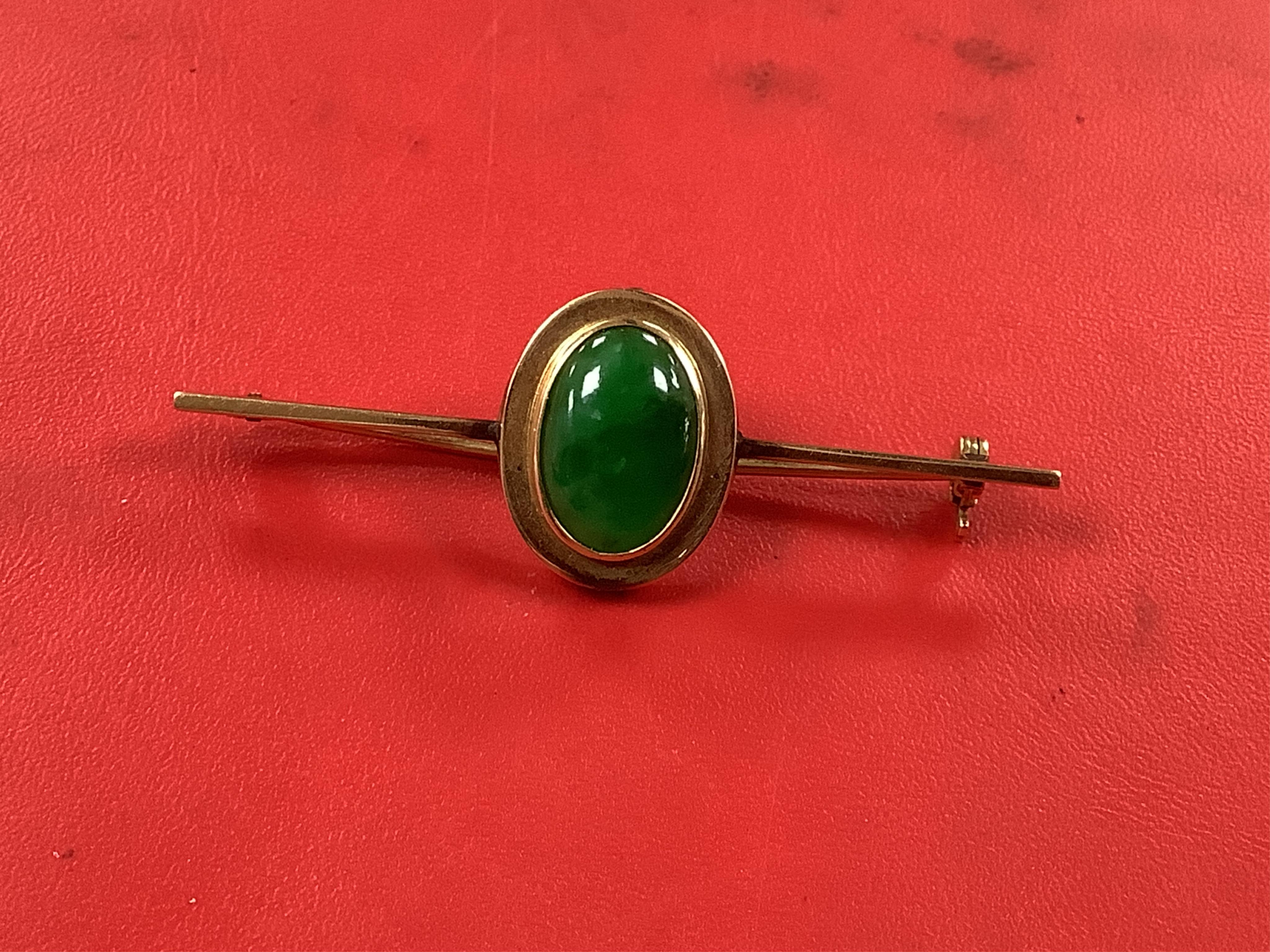 Sundry jewellery including a 9ct and gem set crescent brooch, 51mm, a 9ct, garnet and seed pearl set pendant, a 14ct and jade set bar brooch and a pair of gem set ear studs. Condition - fair to good